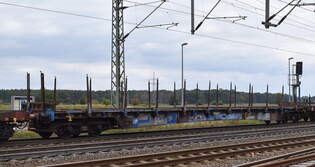 Langer Drehgestell-Flachwagen mit Rungen vom Einsteller Touax Rail Group mit deutscher Registrierung mit der Nr.