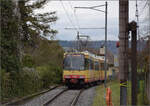 Die Strassenbahn  Be 4/8 003  alias 94 800 450 003-9 D-TVYS hat auf dem Weg nach Chavornay die Haltestelle St-Eloi verlassen. Dezember 2025.