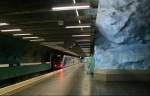 Stadion, T14. Der Abzweig stmalstorg - Tekniska hgskolan mit der Zwischenstation Stadion ging am 30. September 1973 in Betrieb. Die Station besteht aus zwei Bahnsteigrhren. Die Felsen wurden lediglich mit einer Spritzbetonschicht versehen, was den Hhlencharakter des Tunnenbauwerkes untersttzt. Bei smtliche ab den 70er Jahren des letzten Jahrhunderts gebauten unterirdischen Station in Stockholm kommt diese Bauweise zum Einsatz. ber den Bahnsteigen wurde hier ein Metallgitter eingehngt, wohl auch zum Auffangen evtuell abbrechender Betonstcke. 21.08.2007 (Matthias)